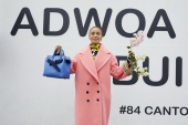 Adwoa Aboah in a coral wool-cashmere cocoon coat and carrying The small Belt Bag c Courtesy of Burberry_Juergen Teller