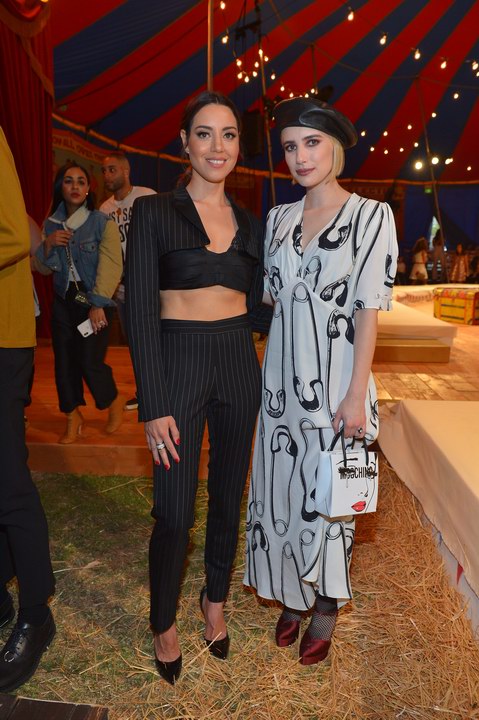 Aubrey Plaza; Emma Roberts - BURBANK, CA - JUNE 08: Aubrey Plaza (L) and Emma Roberts attends the Moschino Spring/Summer 19 Menswear and Women's Resort Collection at Los Angeles Equestrian Center on June 8, 2018 in Burbank, California.  (Photo by Donato Sardella/Getty Images for Moschino)